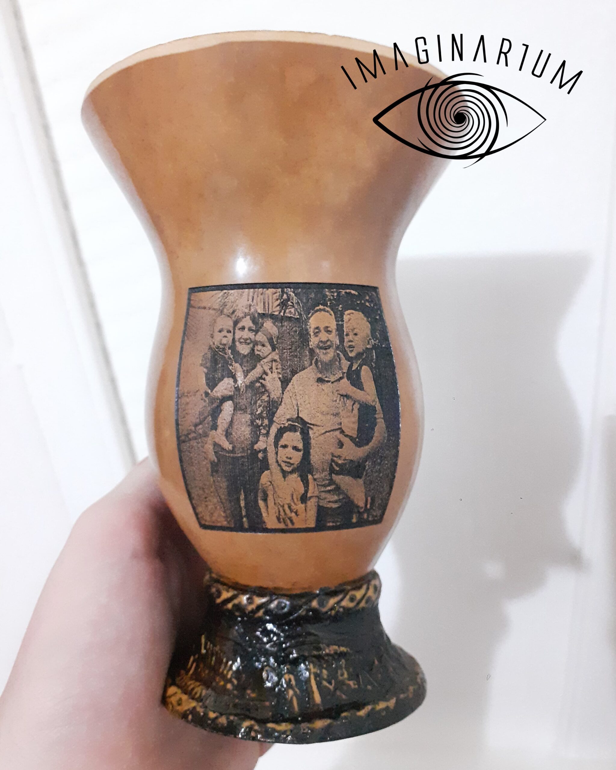 Cuia de chimarrão personalizada com imagem de família ao ar livre, cenário com árvores ao fundo, senhora com duas crianças no colo e senhor abraçando outras duas crianças